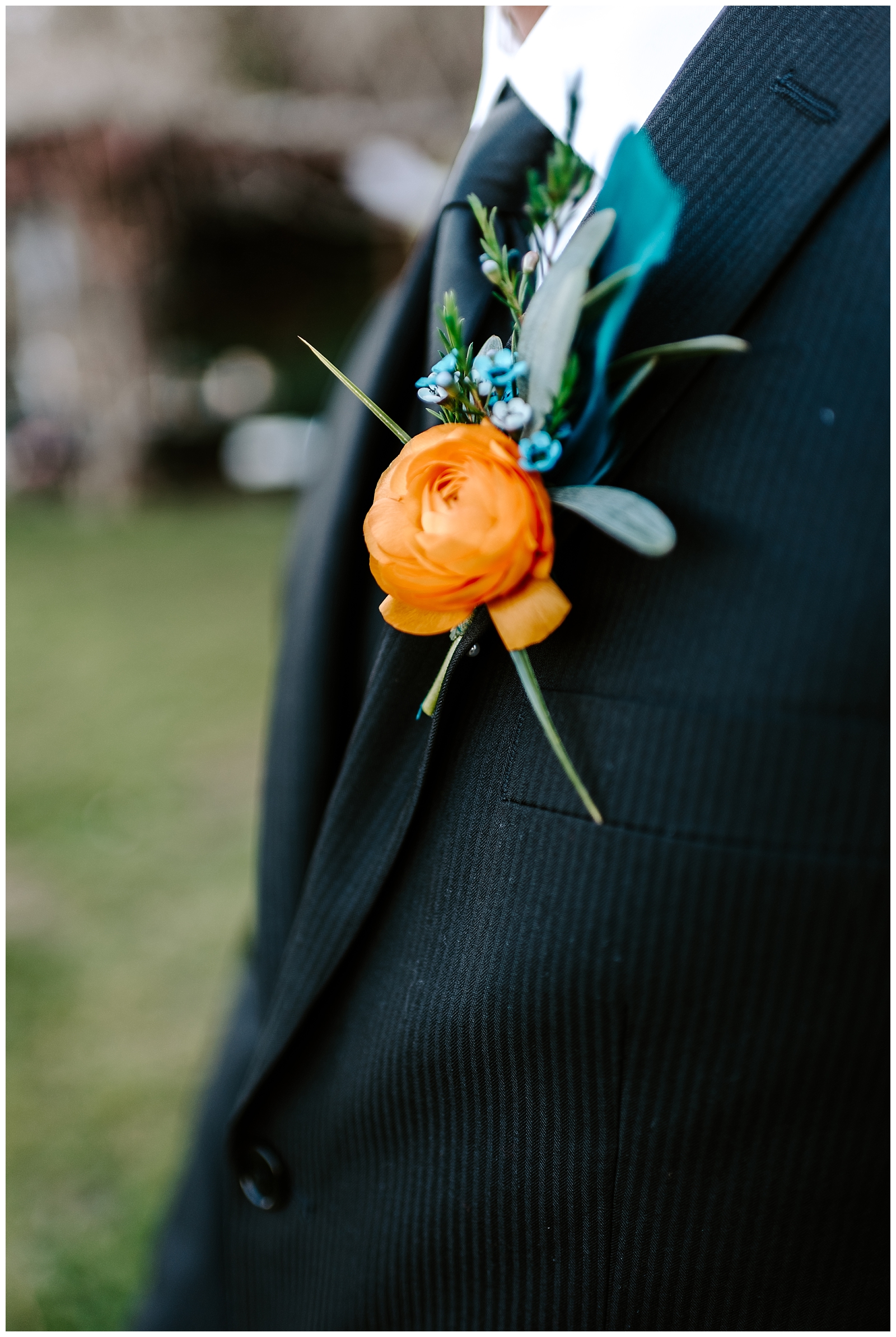 groom holds the bridal bouquet during their mountain elopement