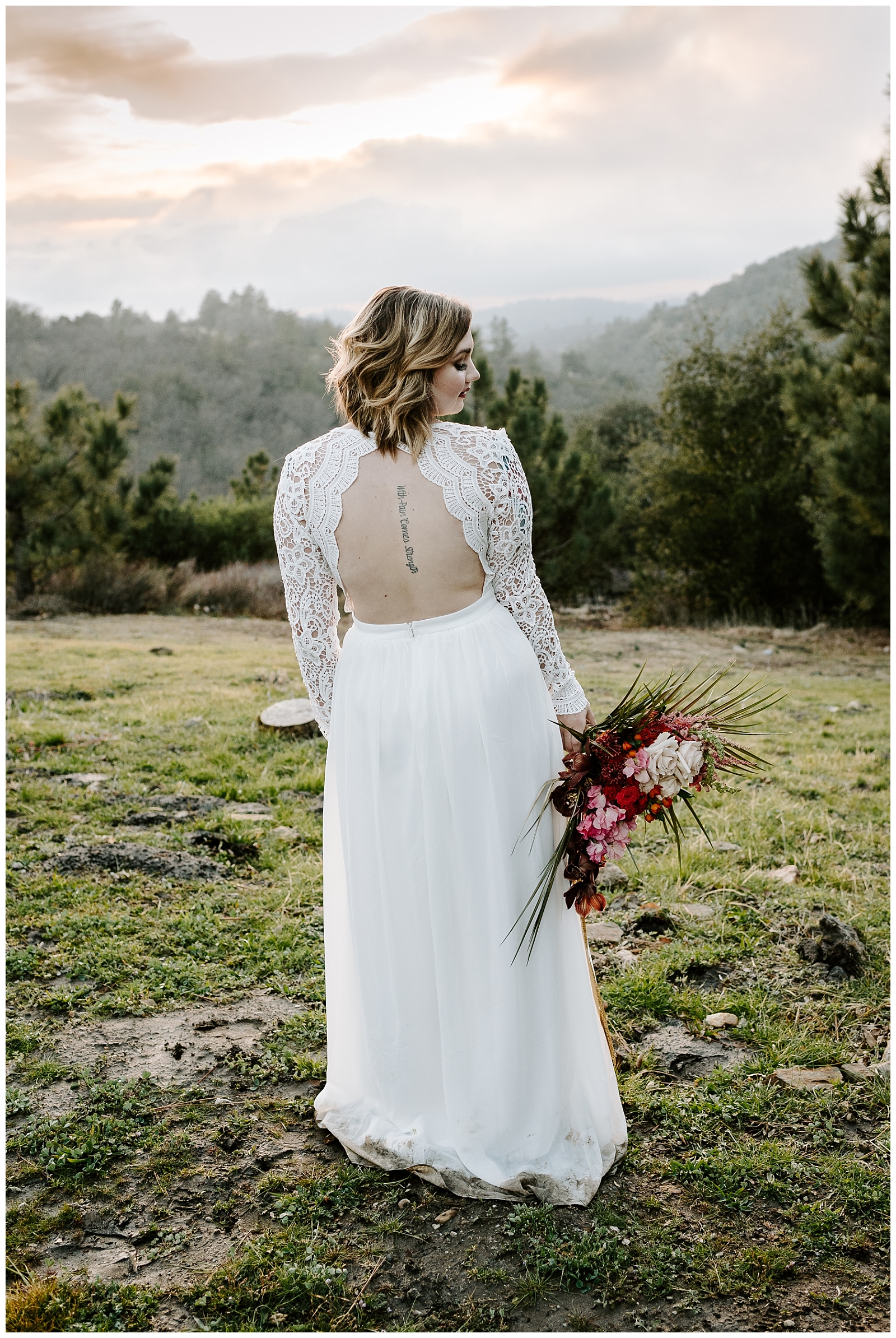 beautiful bride enjoys the mountain views holding her bouquet