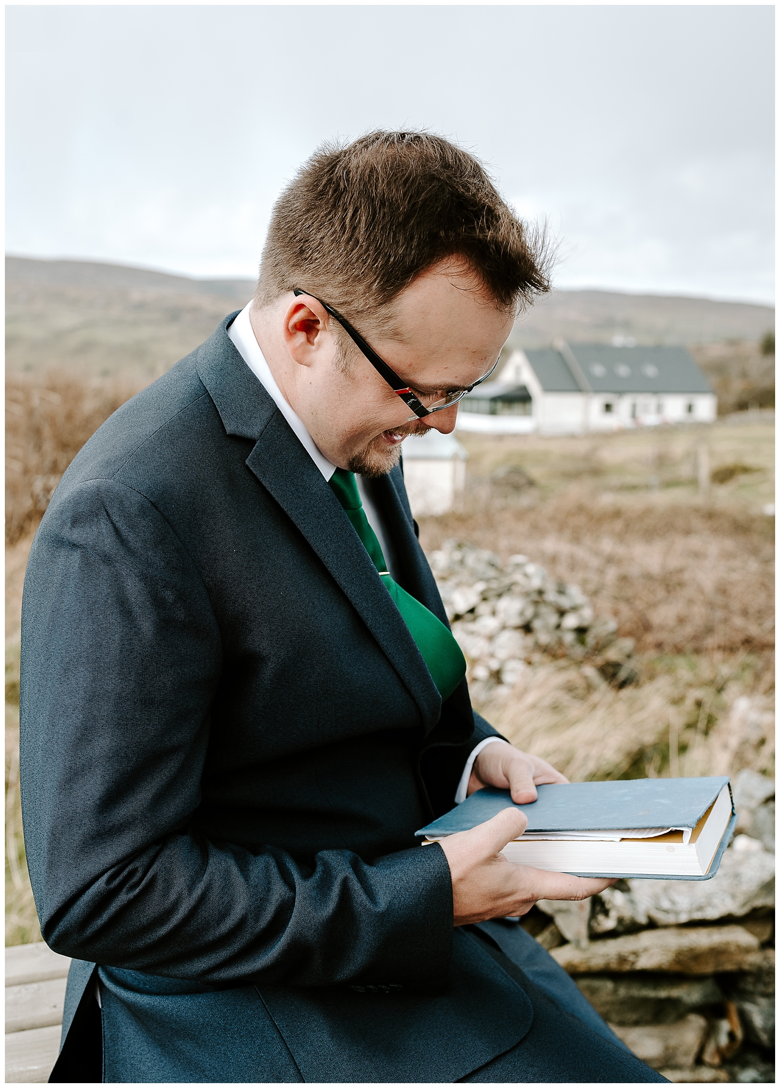 Groom reading a letter from his bride during their Ireland elopement.