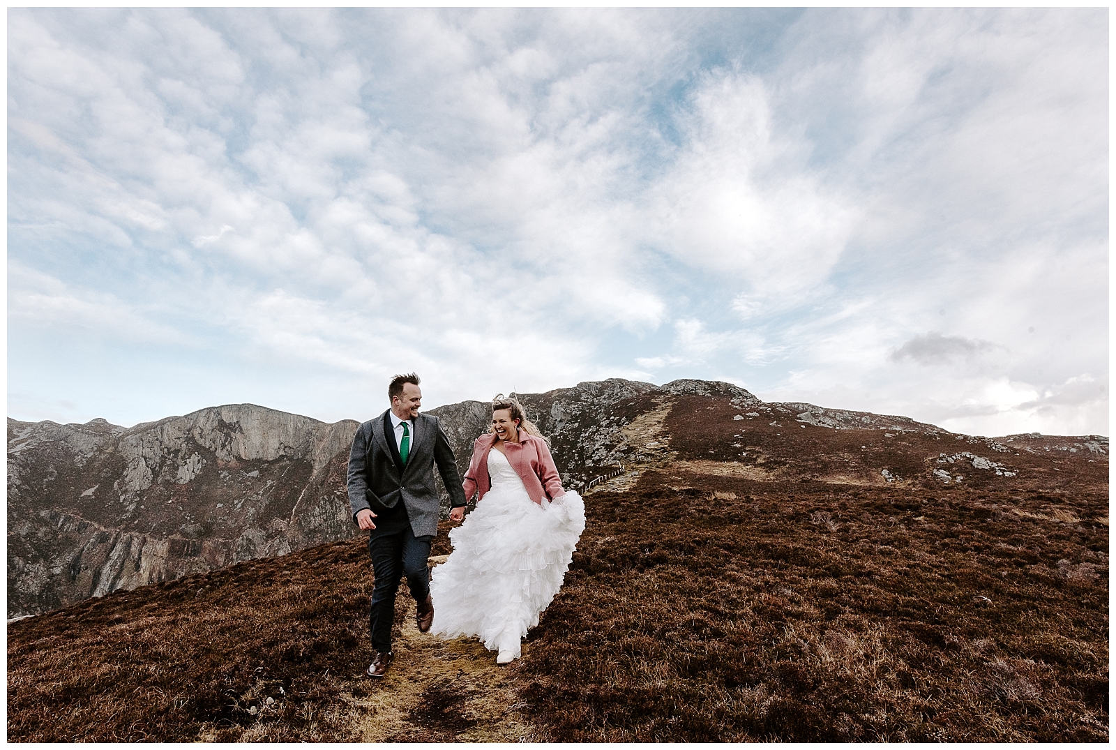 adventurous couple walks along the cliffs in Ireland 