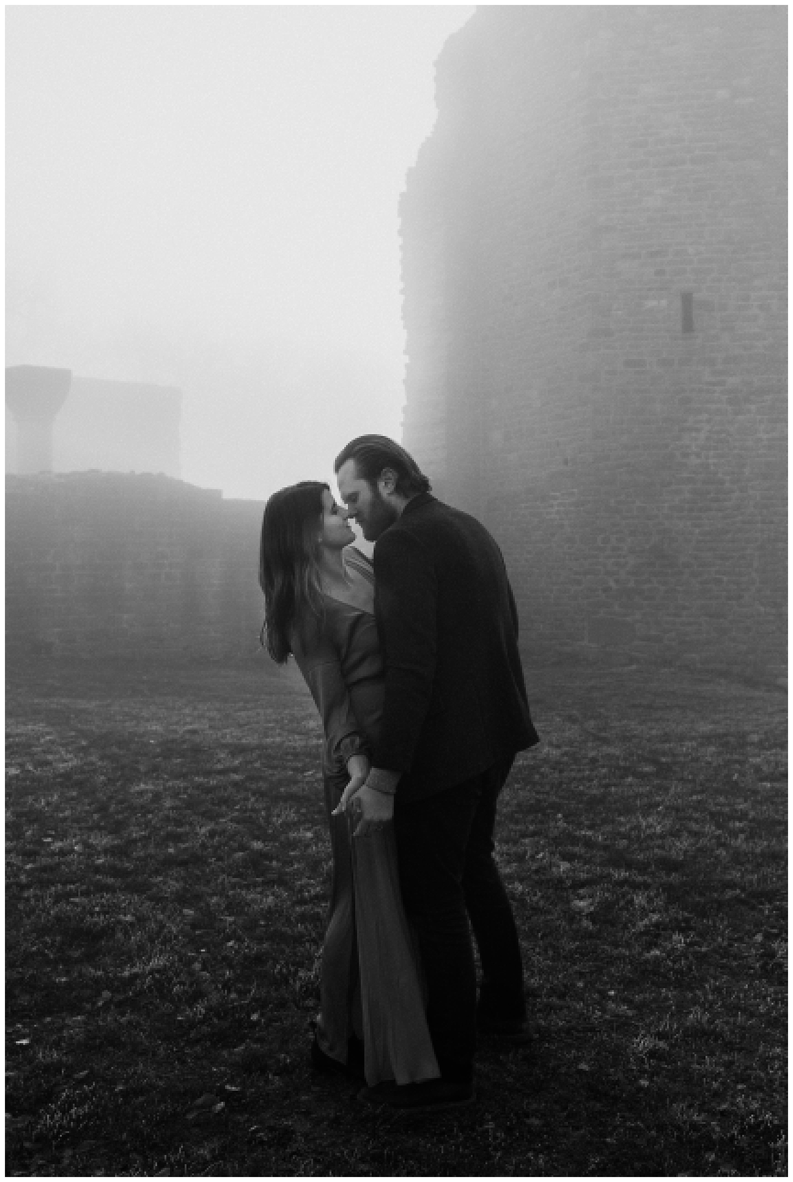 adventurous couples dances in the fog during their elopement