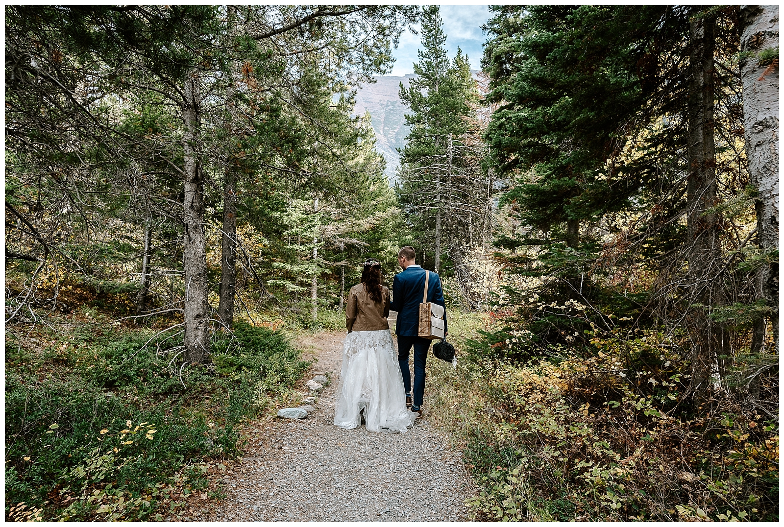 Strolling through the forest at their Lake McDonald Elopement