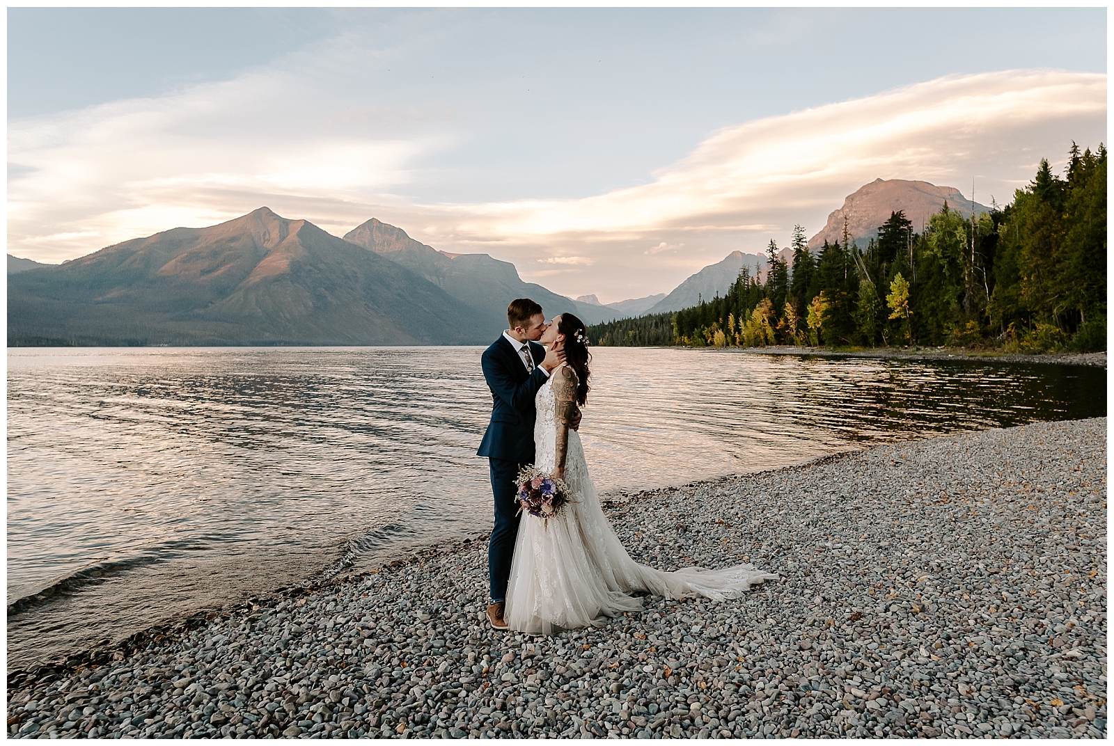 adventurous couple shares a kiss on Lake McDonald