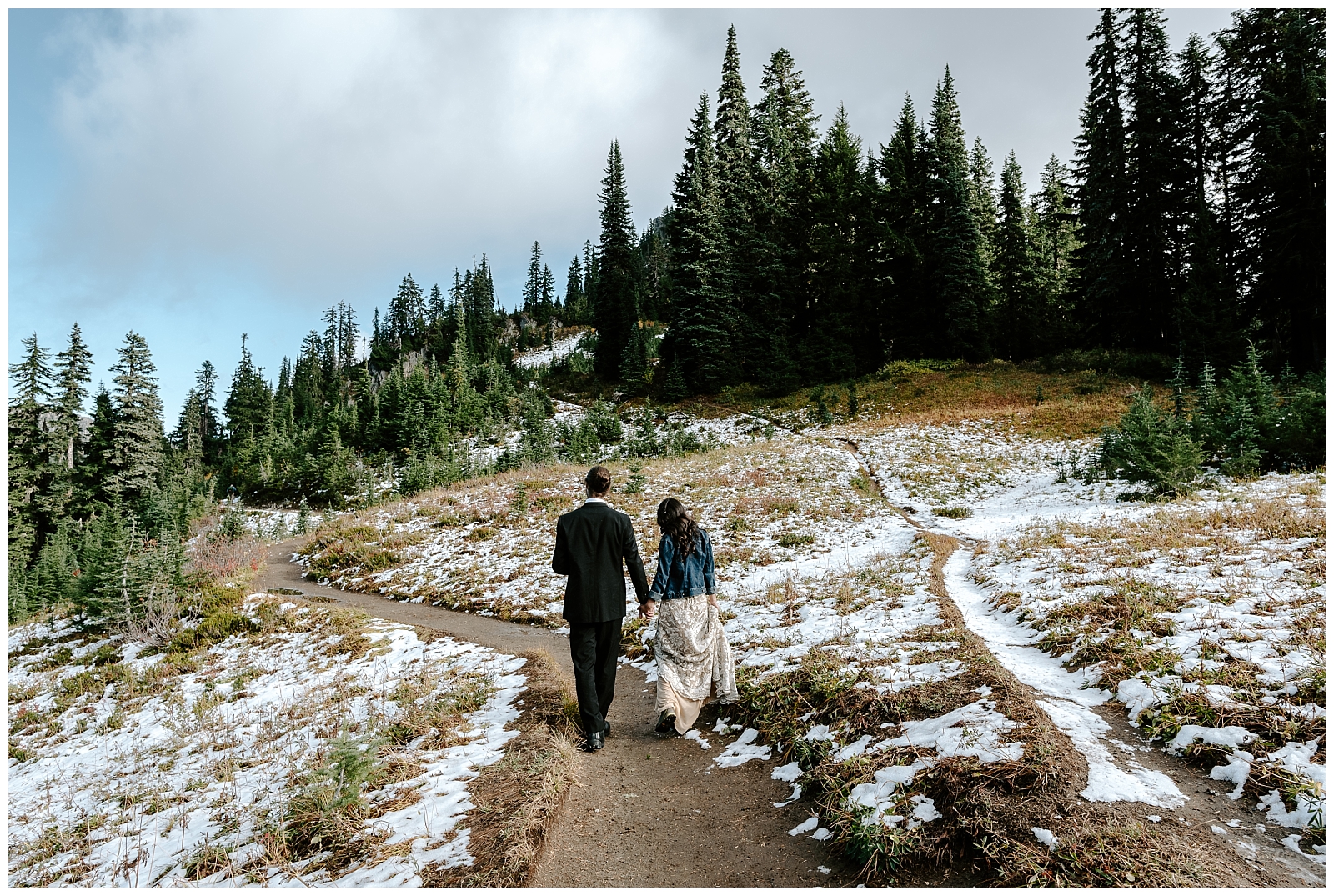 adventurous couple hikes in the snow